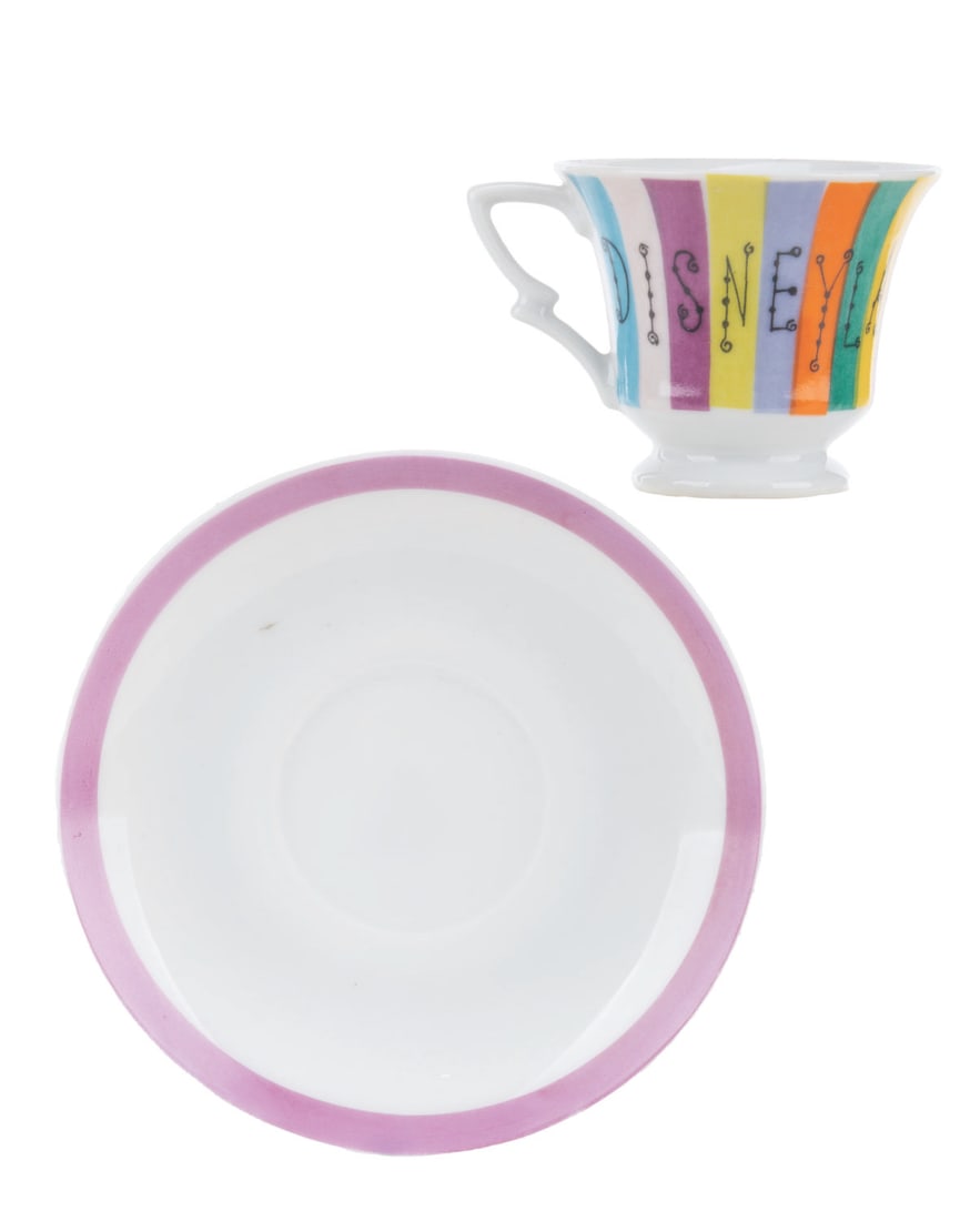 A Disneyland Souvenir Cup and Saucer.: (Disneyland, 1960s-70s) A multi-colored souvenir cup and saucer from Disneyland. The 4.5" saucer and 2" tall cup are in very good condition with very light wear from display.