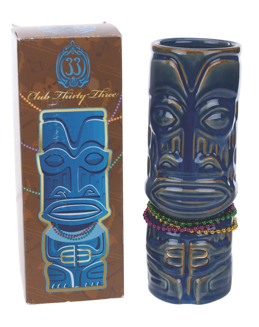 A SHAG Club 33 Mardi Gras Blue Mug.: (Disneyland, 2022) A Club 33 Mardi Gras tiki mug designed by SHAG, complete with its original beads. Released in a limited edition of 2500, the mug features Club 33's logo on the reverse. Measuring 8"