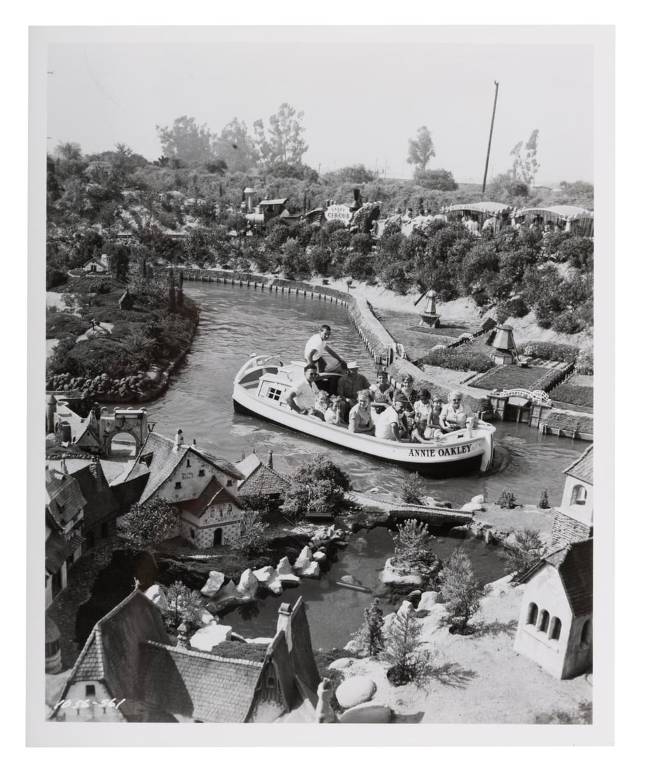 A Disneyland Storybook Land Canal Boats Publicity Photo.: (Disneyland, 1956) An early publicity photo of Disneyland’s Storybook Land Canal Boats attraction with Casey Jr. in the background. Measuring 8" x 10", the photo is in fine condition.