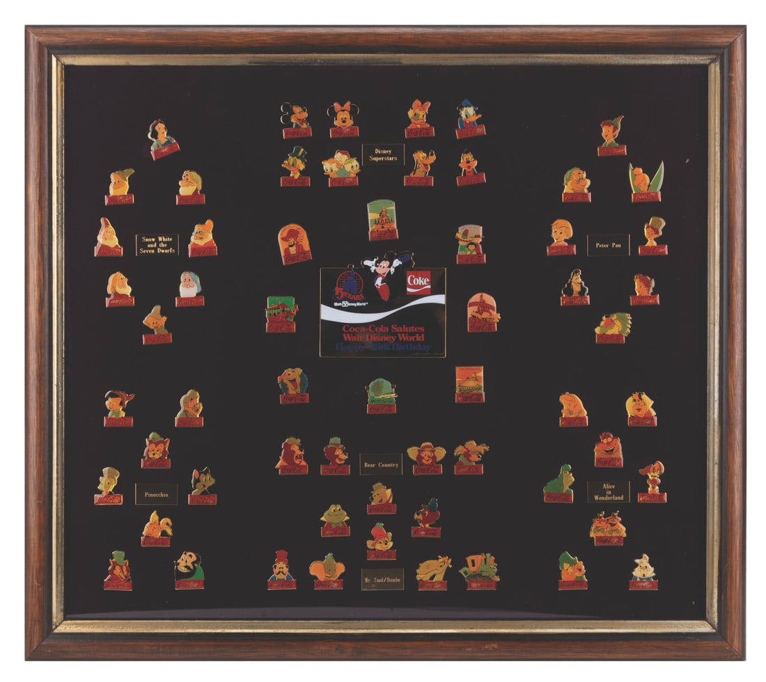 A Framed Set of Walt Disney World 15th Anniversary Coca-Cola Pins.: (Walt Disney World, 1985) A framed set of 60 pins from the Coca-Cola Salutes Walt Disney World collection, celebrating the Resort's 15th anniversary. Included are pins of characters from "Snow White a