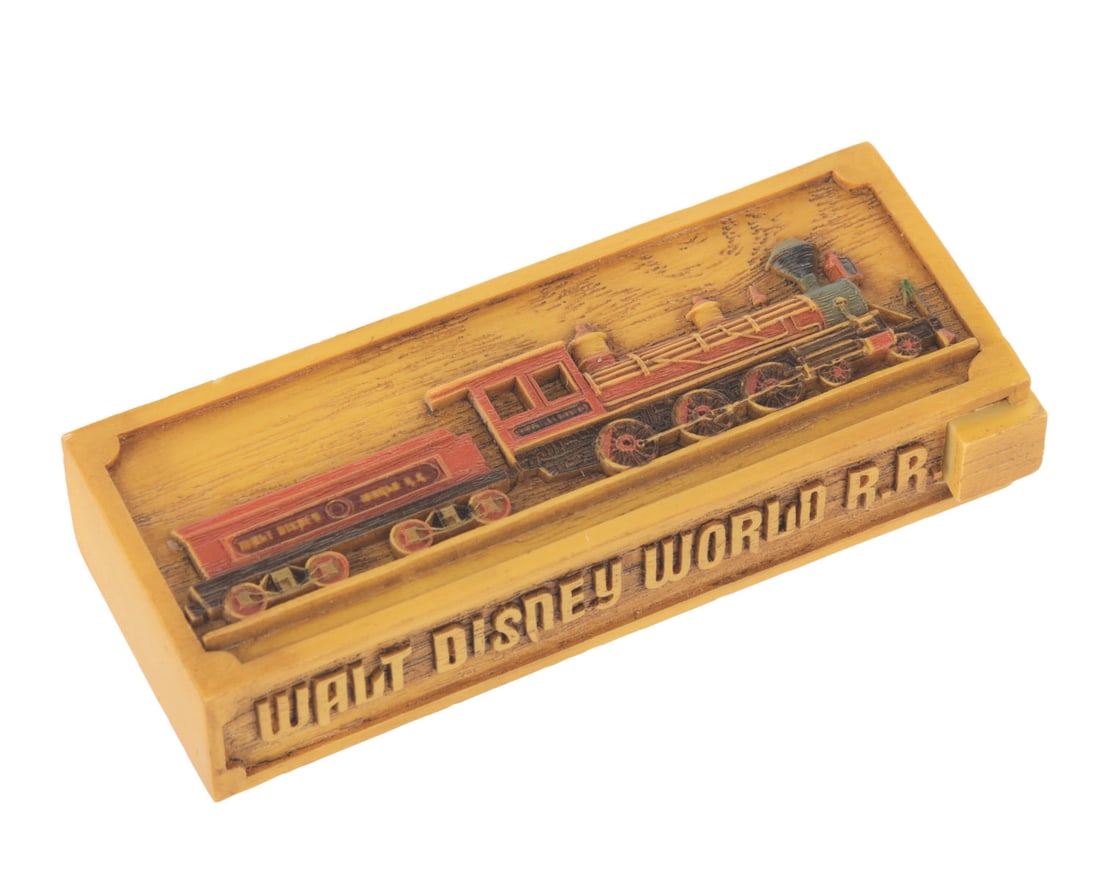 A Walt Disney World Railroad Olszewski PokitPal.: (Olszewski, 2008) A Walt Disney World Railroad attraction PokitPal trinket box designed by Robert Olszewski. Measuring 3.25", the trinket box is in very good condition with light wear.