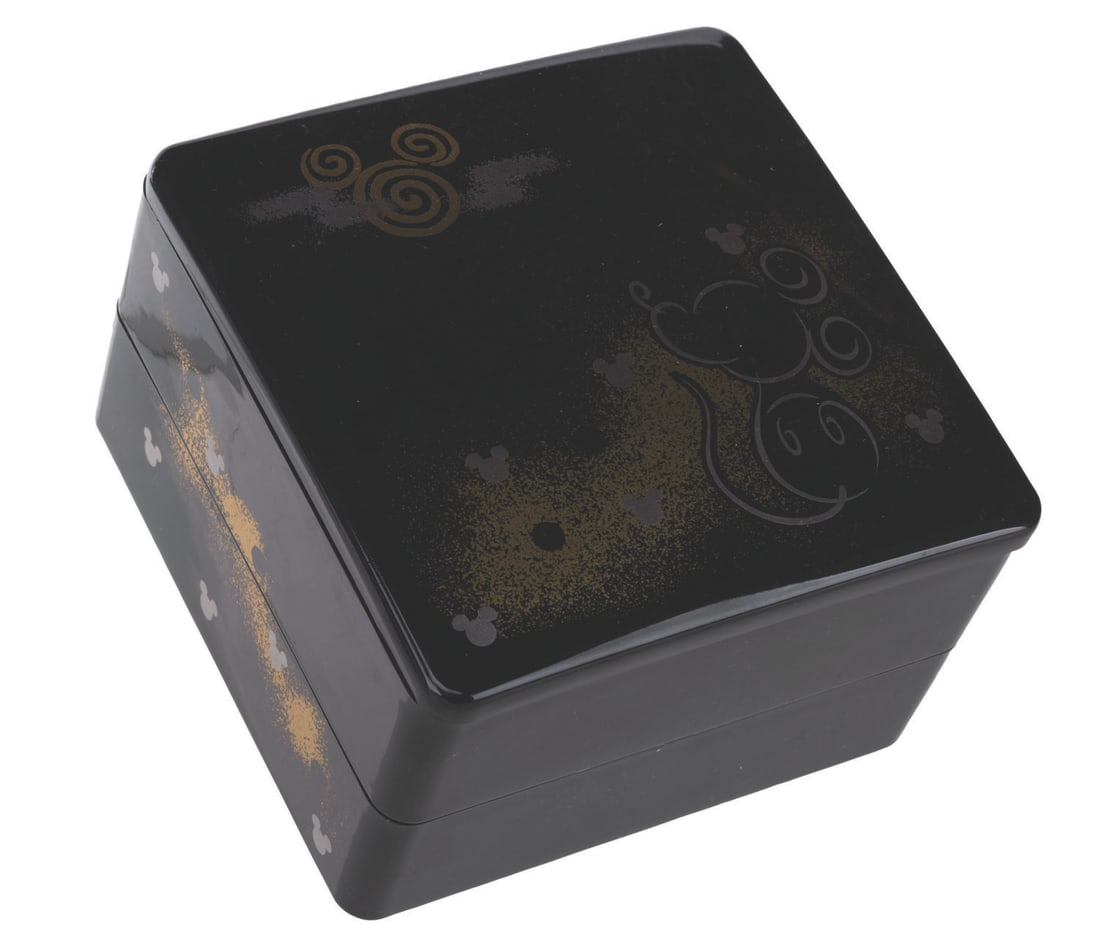 A Tokyo Disney Resort Souvenir Bento Box.: (Tokyo Disney, 2000s) A souvenir bento box from the Tokyo Disney Resort. The black plastic container with Mickey Mouse designs has two removable compartments. Measuring 5.25" x 5.25" x 3.5" tall, the 