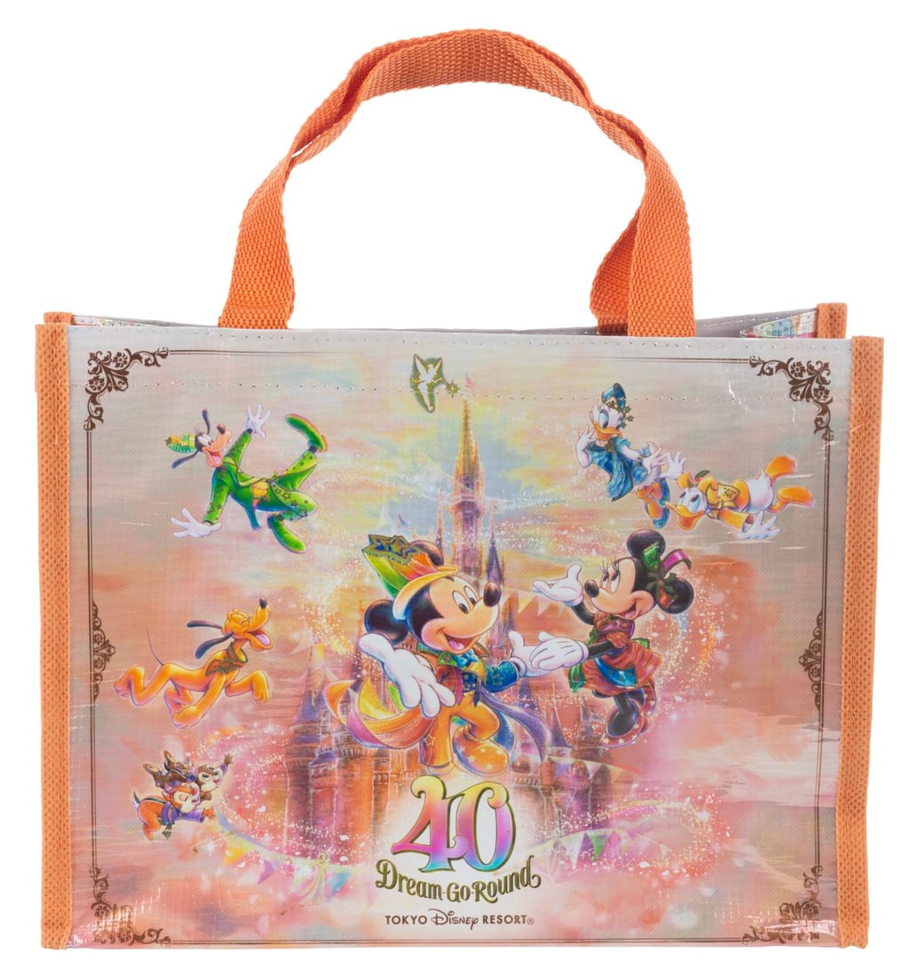 A Tokyo Disneyland 40th Anniversary Tote Bag.: (Tokyo Disney, 2023) A Dream-Go-Round tote bag released for the 40th anniversary of the Tokyo Disney Resort. Measuring 10.5” x 3” x 7.5”, the insulated bag is in fine condition.