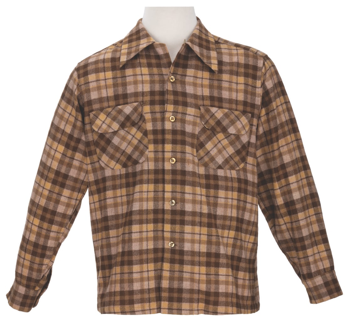 A Fess Parker Flannel Costume Shirt.: (Western Costume, 1950s-60s) A flannel shirt worn by Fess Parker in one of his many Western roles. The brown and gold wool flannel retains its original Western Costume label bearing Parker's name,