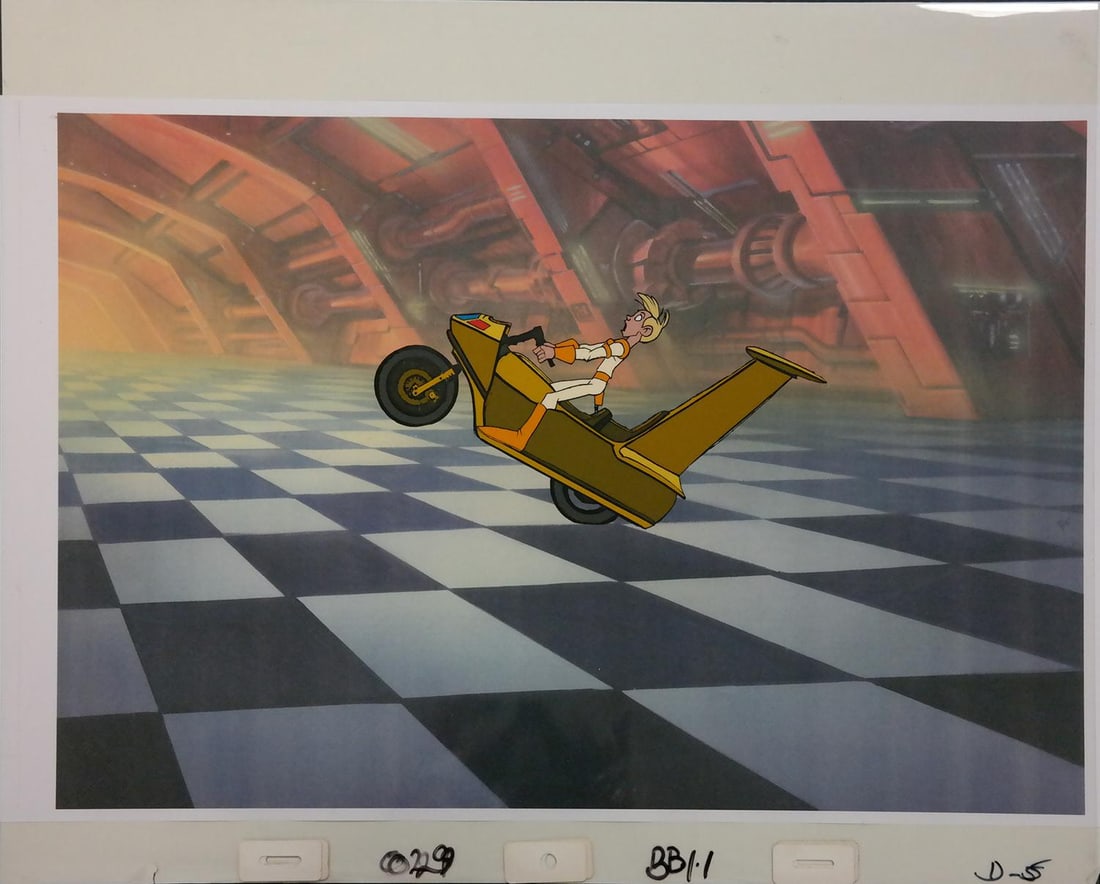 A "Space Ace" Original Multi-Layer Production Cel.: (Bluth, 1983) A multi-layer production cel of Dexter on his bike from the LaserDisc video game "Space Ace," with a color copy background. Following the success of "Dragon's Lair," Don Bluth's next
