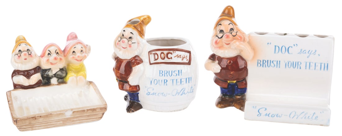 A "Snow White" Ceramic Toothbrush Holder and Soap Dish Collection.: (Enesco, 1960s ) A collection of "Snow White and the Seven Dwarfs" soap dish and toothbrush holders. Included are two different holders featuring Doc with room for toothbrushes and a tube of toothpast