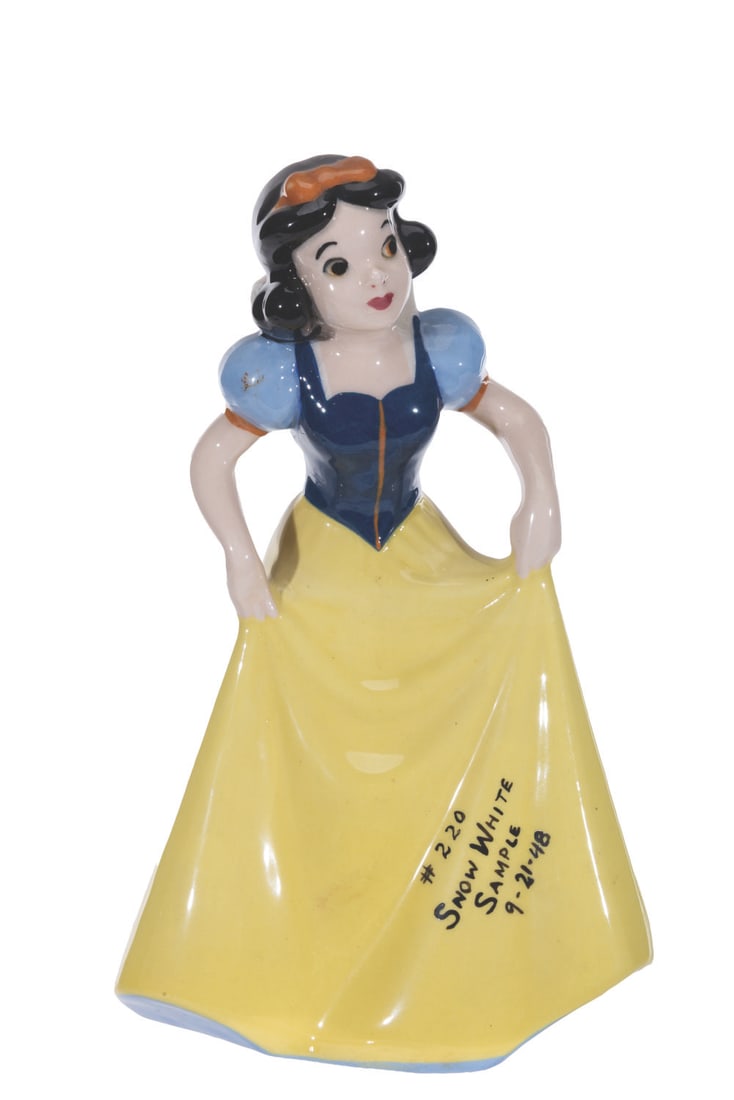 A Rare Snow White Figurine Sample by Shaw.: (Shaw, 1948) A rare production sample of a porcelain Snow White figurine by Evan K. Shaw Pottery. Written on her dress in black marker is "#220 Snow White Sample 9-21-48." Measuring 9" tall, the figur