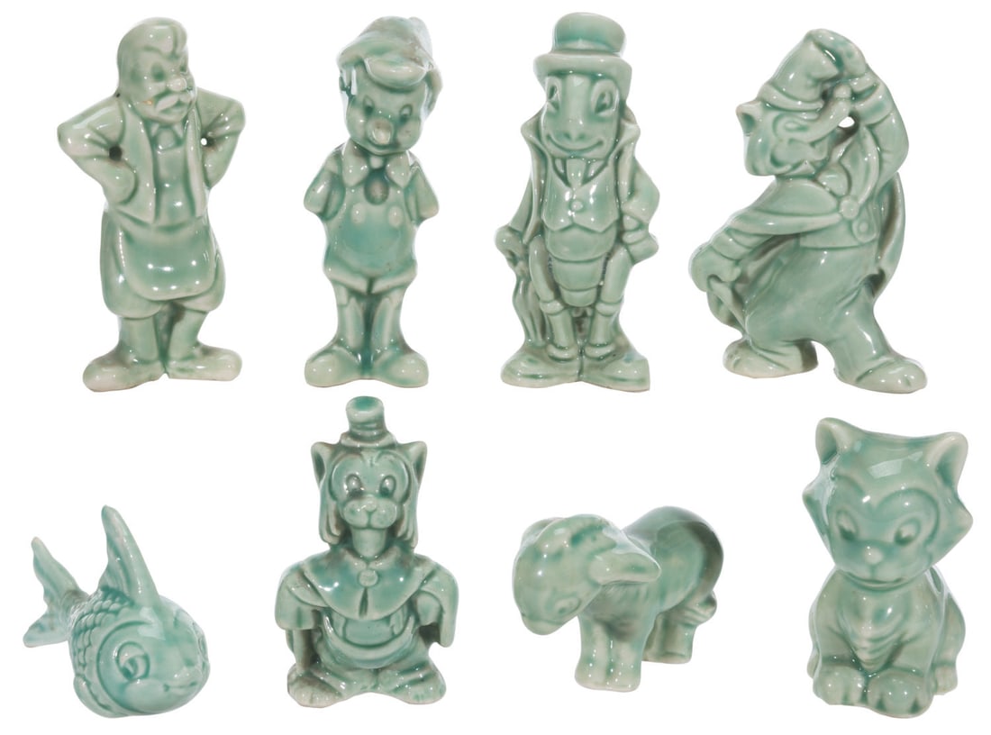 A Set of National Porcelain "Pinocchio" Figures.: (National Porcelain, 1940s) A set of eight miniature ceramic"Pinocchio" figures, including Pinocchio, Geppetto, Jiminy Cricket, Cleo, Figaro, Honest John, Gideon, and a Donkey. Measuring 1" x 2" x