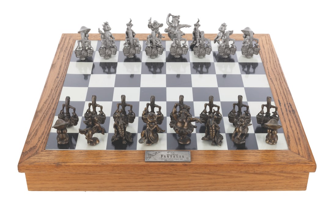 A Pewter "Fantasia" Chess Set.: (Rawcliffe Corp, 1991) A pewter "Fantasia" chess set with Sorcerer Mickey as the King, Hyacinth Hippo as the Queen, and the Magic Brooms as the Pawns. Numbered 428/1500, the 32-piece set includes a