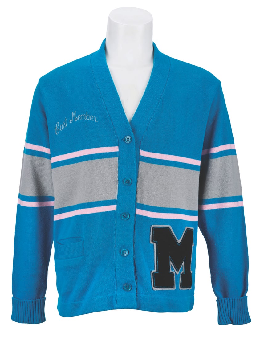 An Early Disney Store Cast Member Cardigan.: (Disney, 1980s) An original Cast Member costume cardigan from the early years of the Disney Store. Unlabeled but likely a women's size XL, the acrylic sweater displays in very good condition with