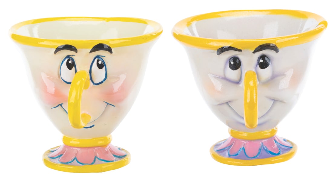 A Pair of "Beauty and the Beast" Disney Store Display Figures.: (Disney Store, 1990s-2000s) A pair of "Beauty and the Beast" Disney Store display figures, one of Chip and one of his cup siblings. Measuring 3.5" x 4.5" x 4.25" to 4.75" tall each, the fiberglass