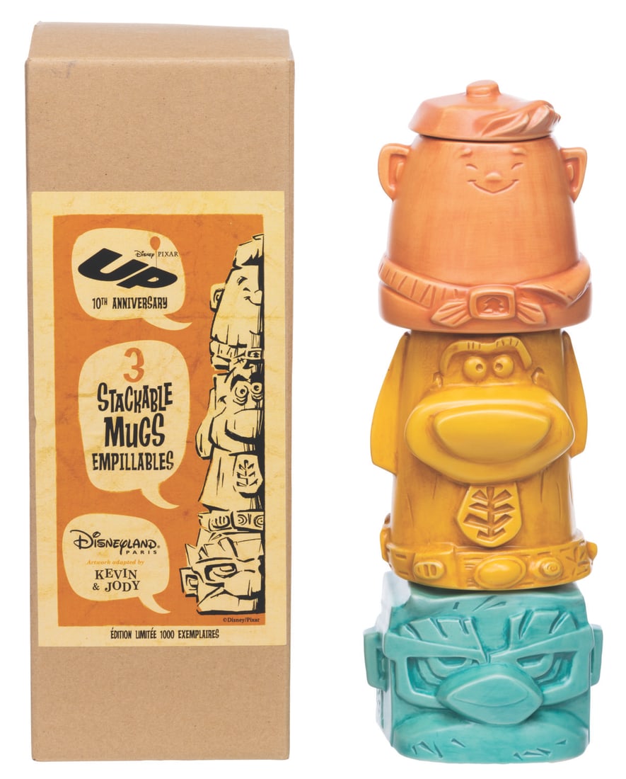 A Pixar's "Up" Stackable Tiki Mug Set.: (Disneyland Paris, 2019) A collection of stackable mugs themed after the stars of Pixar's "Up," sold exclusively at Disneyland Paris. The mugs of Russell, Carl, and Dug were designed by Kevin Kidney