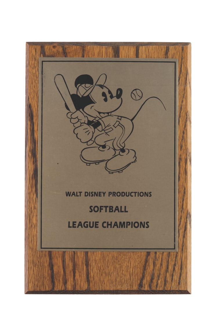 A Walt Disney Productions Softball League Champions Plaque.: (Disney, 1980s) A plaque given to the Walt Disney Productions Softball League champions. Walt Disney started the Studio's employee softball games in the 1940s to foster team spirit and camaraderie, a 