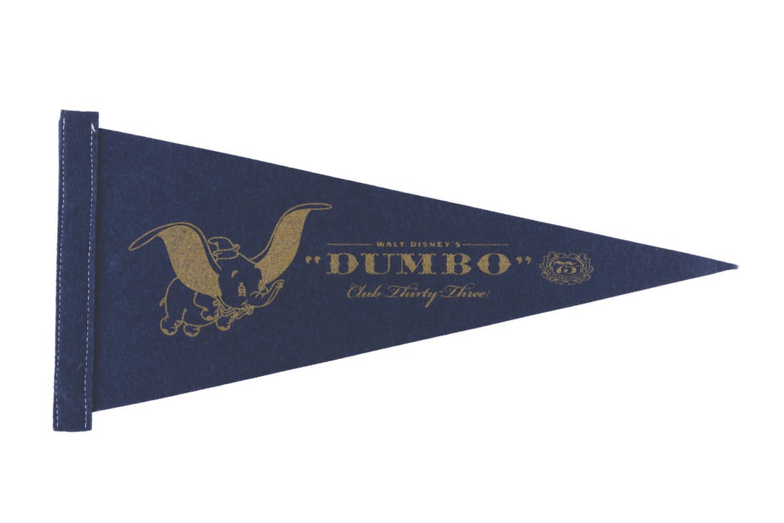 A Club 33 "Dumbo" 75th Anniversary Pennant.: (Disneyland, 2016) A pennant from the exclusive Club 33 in Disneyland, celebrating the 75th anniversary of "Dumbo" in 2016. Measuring 8.25" x 17.5", the felt pennant is in fine condition.