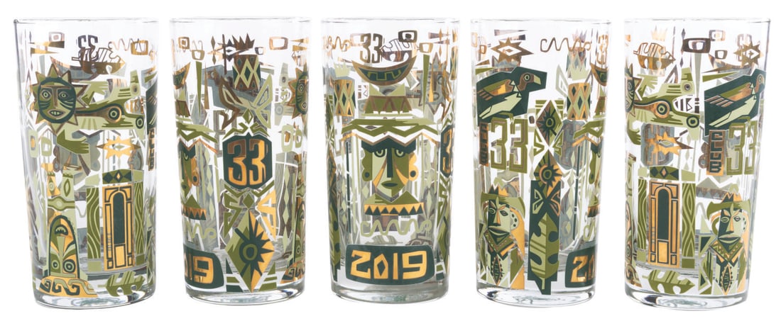 A Set of Club 33 Tiki Glasses.: . (Disneyland, 2019) A set of five glasses featuring art by Jeff Granito, released exclusively at Club 33 as part of the 2019 Summer of Tiki collection. Measuring 5.75" tall and 2.75" in diameter,