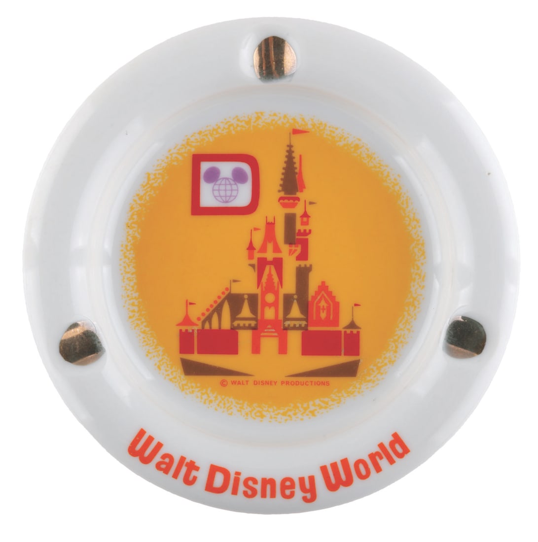 A 1970s Walt Disney World Ashtray.: (Walt Disney World, 1970s) A ceramic ashtray featuring a stylized Cinderella Castle. Measuring 5" in diameter and 0.75" tall, the ashtray is in fine condition with very light wear underneath.