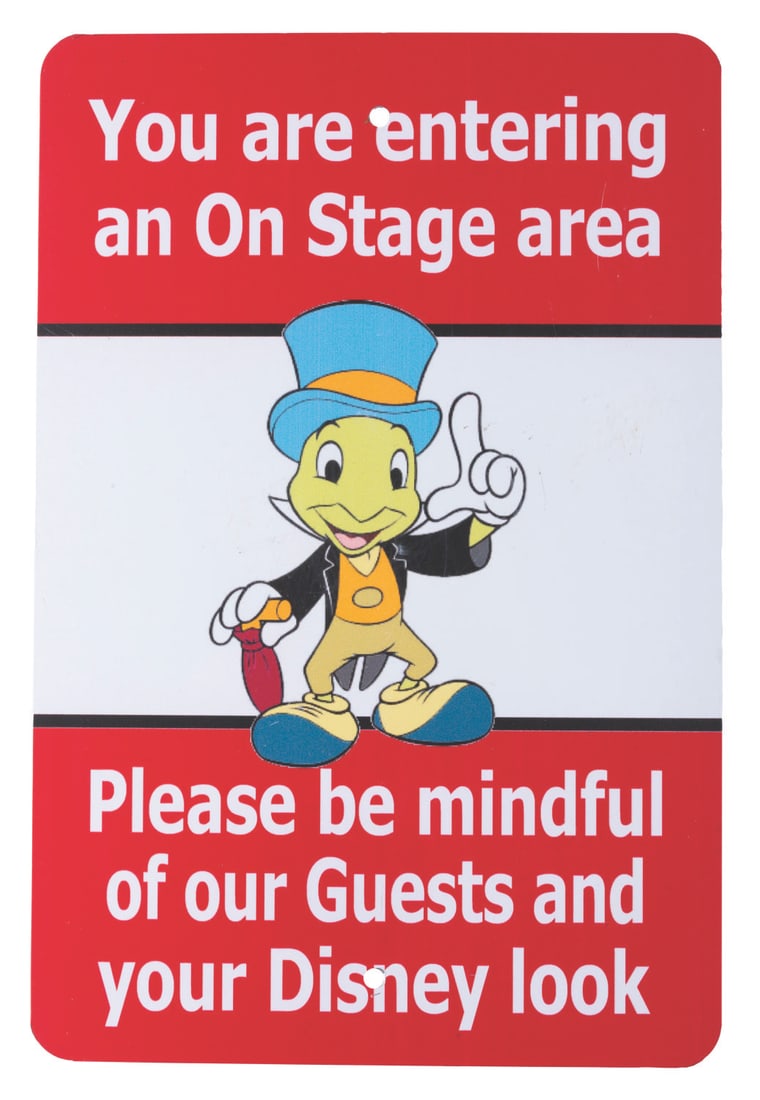 A Walt Disney World "Entering Onstage Area" Sign.: (Walt Disney World, 1990s) A sign displayed backstage at Walt Disney World reminding Cast Members before going onstage to maintain the "Disney Look." Measuring 12" x 18" the sign is in very good,