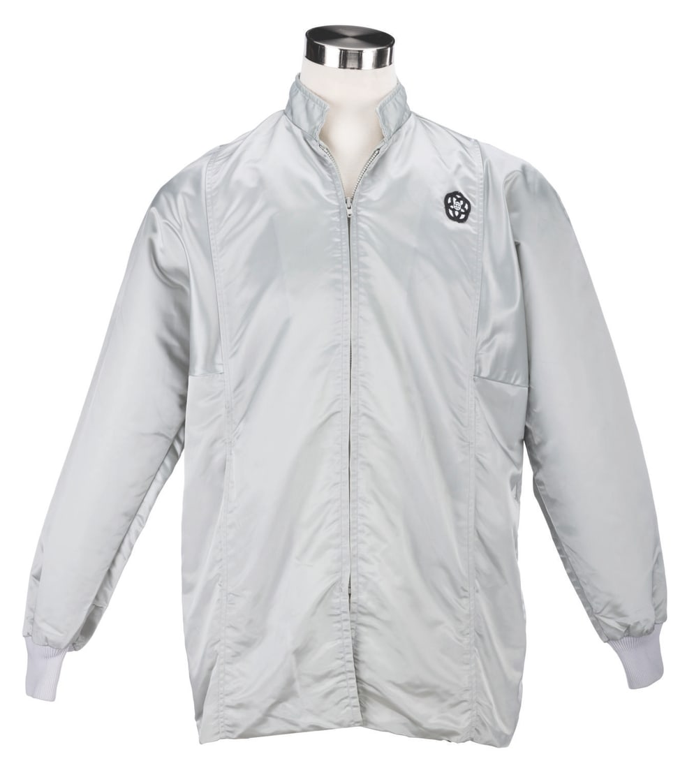 An EPCOT Center Silver Cast Member Jacket.: (EPCOT Center, 1982-94) A silver Cast Member jacket featuring the original EPCOT Center logo. Labeled a size "L" the jacket is in very good condition with wear typical of Park use.