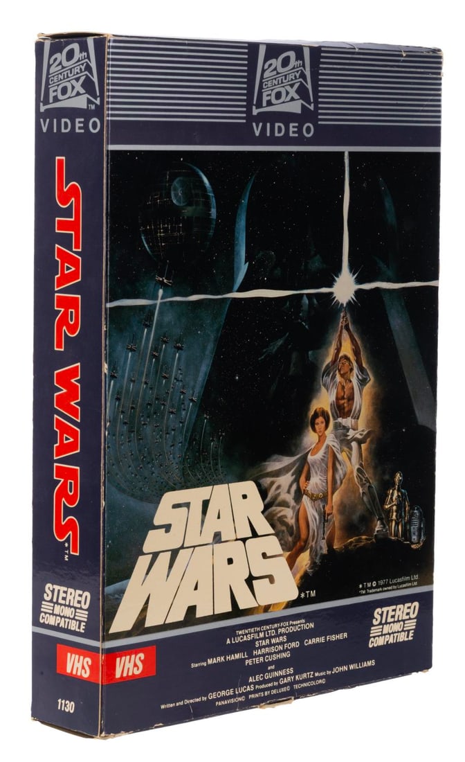A Star Wars VHS/BetaMax Mobile Store Display.: (20th Century Fox, 1982) A rare double-sided hanging store display advertising the first release of "Star Wars" on VHS and BetaMax. Assembled, the display measures 14" x 10" and 2.25" deep and is in