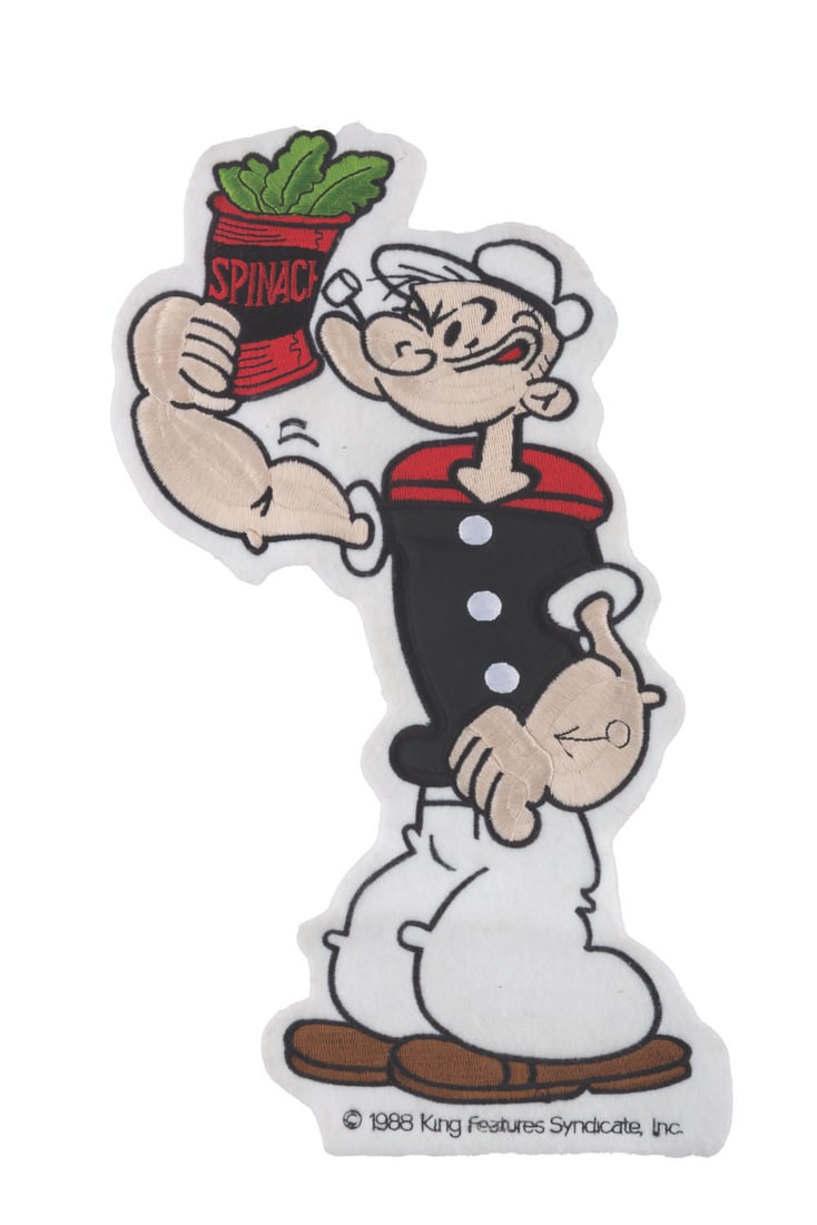 A Large Embroidered Popeye Patch.: (King Features, 1988) A large embroidered patch of Popeye the Sailor Man. Measuring 7.25" x 12.5", the patch is in very good condition with a light stain on the reverse, which is not visible from the