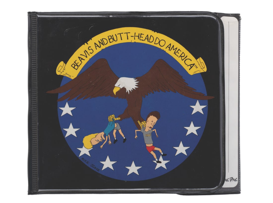 A "Beavis and Butt-Head Do America" CD Carry Case.: (MTV, 1996) A CD case from the Mike Judge film "Beavis and Butt-Head Do America." Measuring 5.25" x 6", the case is in very good condition with light handling wear, and the velcro from one side of