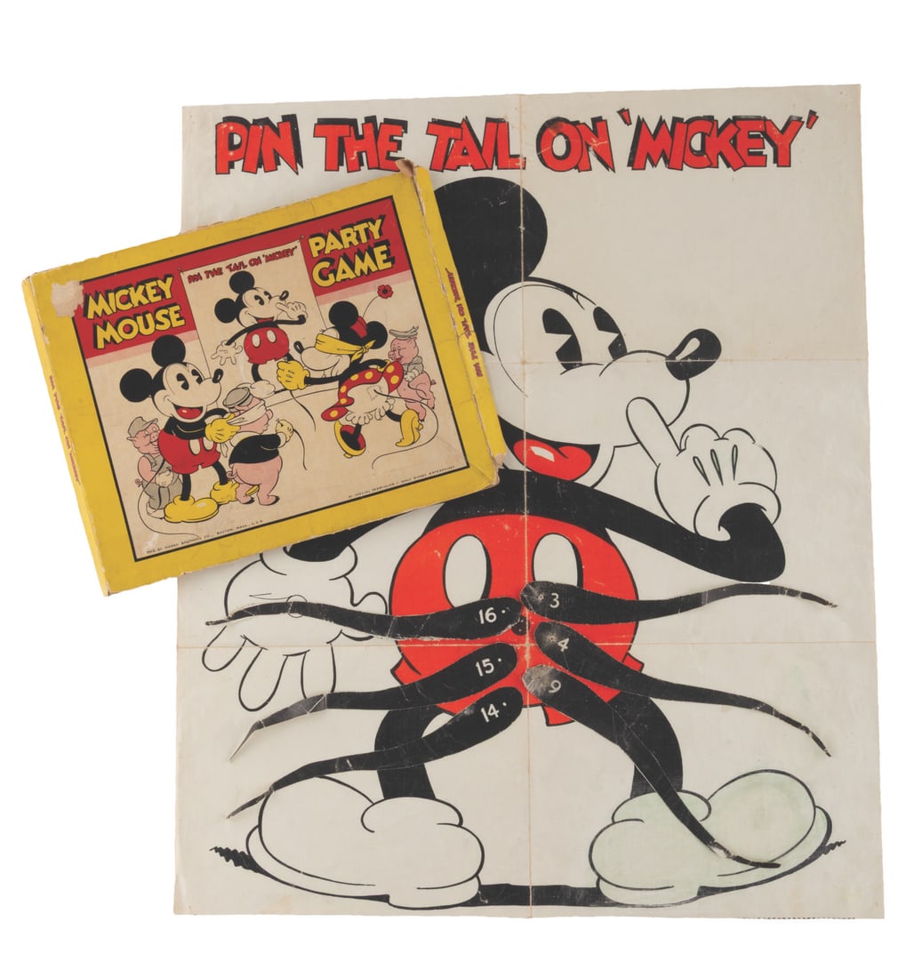 A Pin the Tail on Mickey Party Game.: (Marks Bros, 1930s) A Pin the Tail on Mickey party game by Marks Bros, including the rubberized fabric Mickey poster and six numbered tails. Measuring 9" x 10.5" in the original box, the game and box