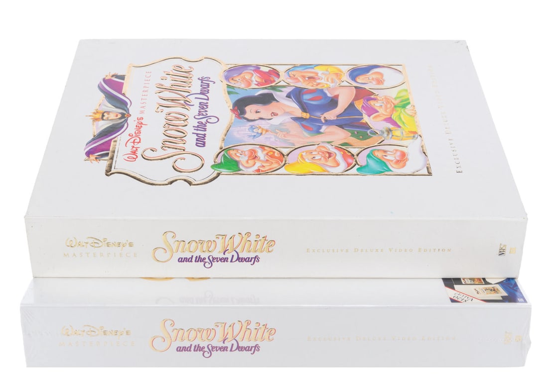 A Pair of "Snow White and the Seven Dwarfs" Deluxe Edition VHS Sets.: (Disney, 1994) A pair of "Snow White and the Seven Dwarfs" deluxe edition VHS sets, the film's first release on home video. Each set includes a VHS of the film, a book on the making of the film, a beh