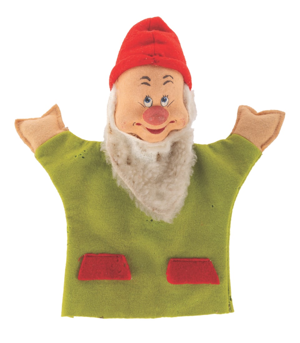 A "Snow White and the Seven Dwarfs" Dwarf Hand Puppet.: (Merrythought, 1950s) A Dwarf hand puppet from "Snow White and the Seven Dwarfs." The felt, cardboard and fabric hand puppet is likely Sneezy or Bashful. Measuring 7" x 9.5" the puppet is in fair cond