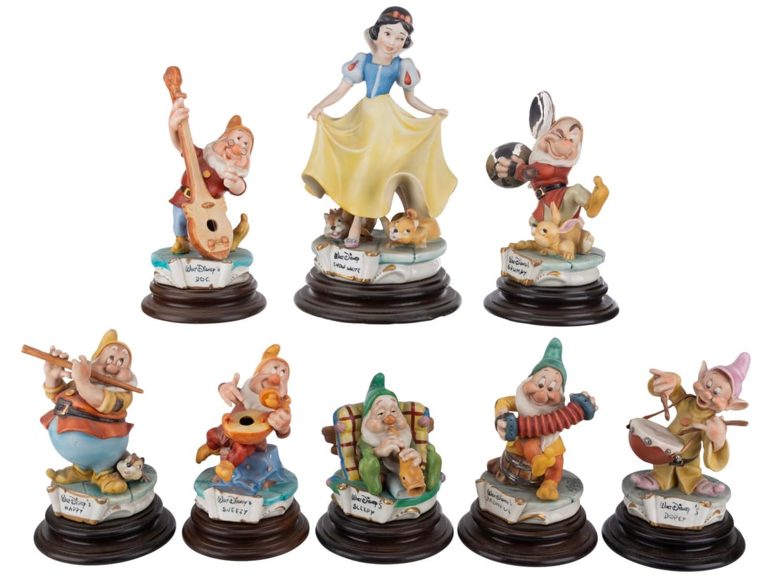 A "Snow White" Seven Dwarfs Capodimonte Figurine Set.: (Capodimonte, 1980s) An exquisite porcelain sculpture set of the eight title characters from "Snow White and the Seven Dwarfs." Designed by Enzo Arzenton for the Capodimonte line, the sculptures were