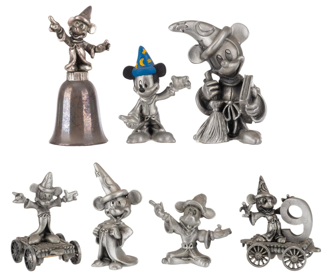 A Collection of Sorcerer Mickey Pewter Figurines.: (Schmid/Hudson/NECS, 1980s-2000) A collection of seven pewter Sorcerer Mickey Mouse figurines. Included are a New England Collector's Society silver bell, one Schmid Mickey numbered 0408, and five