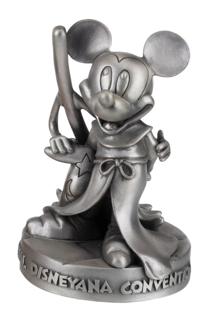 A Pewter Sorcerer Mickey Disneyana Figure.: (Disneyana, 1994) A pewter figure of Sorcerer Mickey with a broom, released in a limited edition of 2,200 exclusively at the 1994 Disneyana convention at Walt Disney World. Standing 4.75" tall, the
