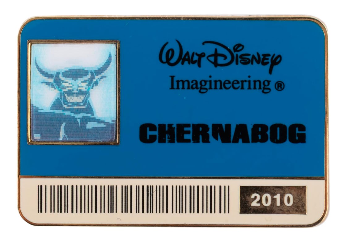 A Chernabog Imagineering Exclusive ID Badge Pin.: (WDI, 2010) A Chernabog commemorative ID badge pin with a lenticular smiling photo feature, released exclusively by Walt Disney Imagineering in an edition of only 300. Measuring 2" x 1.25", the pin