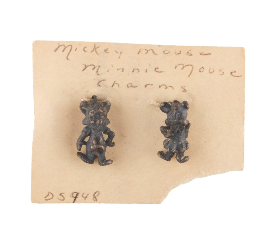 A Mickey and Minnie Mouse Charm Set.: (Disney, 1940s-50s) A pair of tiny Mickey and Minnie Mouse charms. Each measuring 0.5" tall the charms are in good condition with typical tarnish from age.