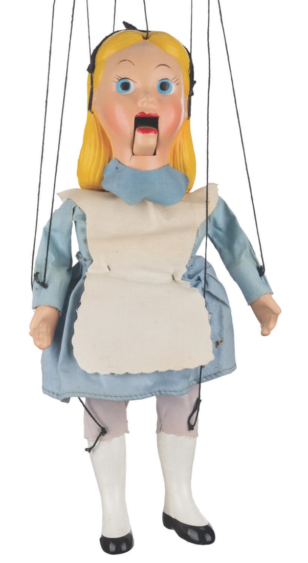 An "Alice in Wonderland" Marionette with Box.: (Peter Puppet Playthings, 1950s) An original Alice marionette by Peter Puppet Playthings. Alice has a composition head, arms, and legs, with fabric clothing, and a movable mouth. Measuring 13" tall