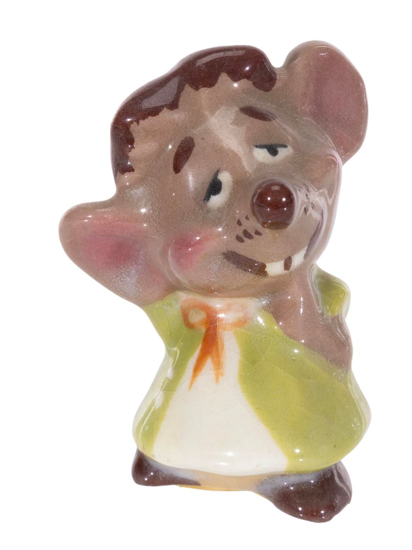 An "Alice in Wonderland" Dormouse Ceramic Figurine.: (Shaw, 1950s) A rare figurine of the Dormouse from "Alice in Wonderland" by Evan K. Shaw. Measuring 2.25" tall, the ceramic displays in good condition with crazing throughout and tape on the bottom.