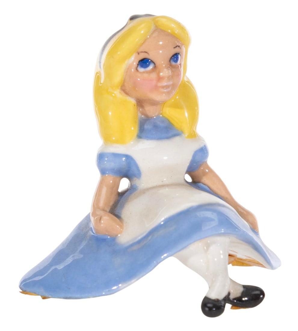 An "Alice in Wonderland" Figurine.: (Hagen-Renaker, 1950s) A rare figurine of Alice from "Alice in Wonderland" by renowned Californian ceramist, Hagen Renaker. Measuring 2" tall, the ceramic displays in very good condition with light