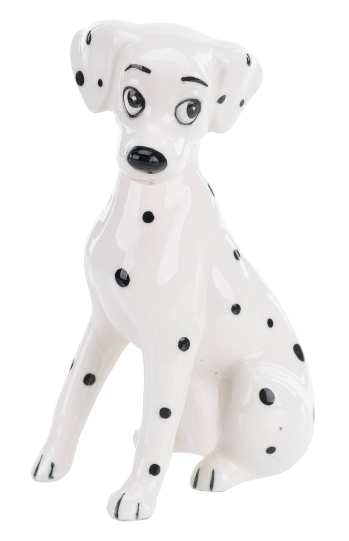 A "One Hundred and One Dalmatians" Perdita Figurine.: (Enesco, 1960s-70s) A ceramic figurine of Perdita from "One Hundred and One Dalmatians." Measuring 2.75" x 1.75" and 4.5" tall, the figurine is in fine condition.