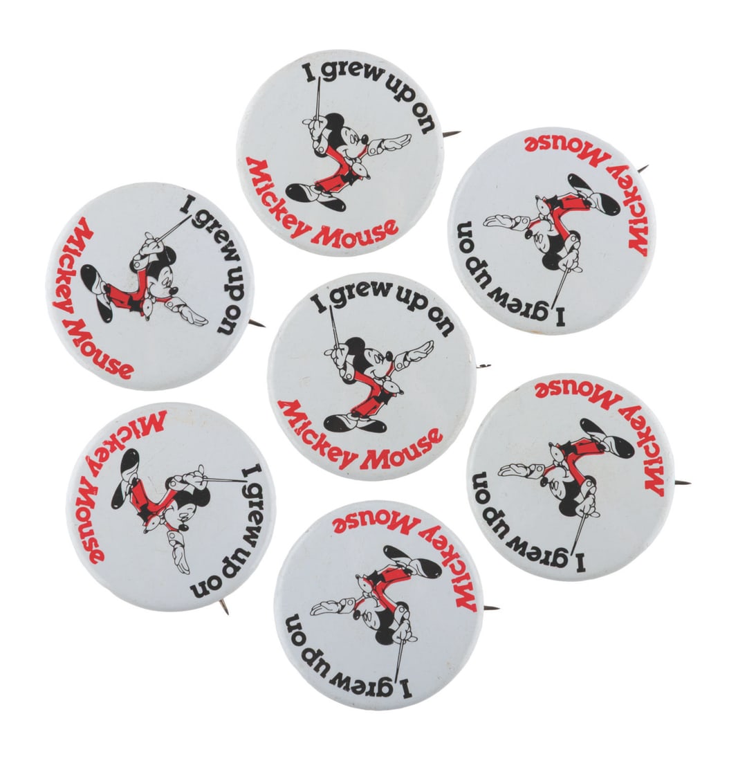 A Collection of "I Grew Up On" Mickey Mouse Buttons.: (Disney, 1970s) Seven “I Grew Up On Mickey Mouse” buttons. Measuring 1.25” in diameter, the buttons are in very good condition with light handling wear.