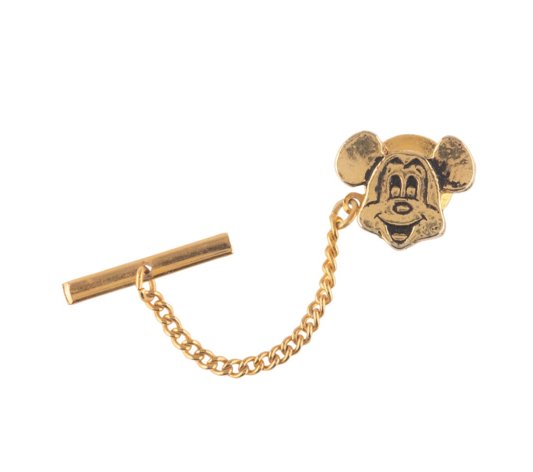 A Mickey Mouse Tie Tack.: (Disney, 1970s-80s) A tie tack in the shape of Mickey Mouse's head. Measuring 0.75 ", the tie tack is in good condition.
