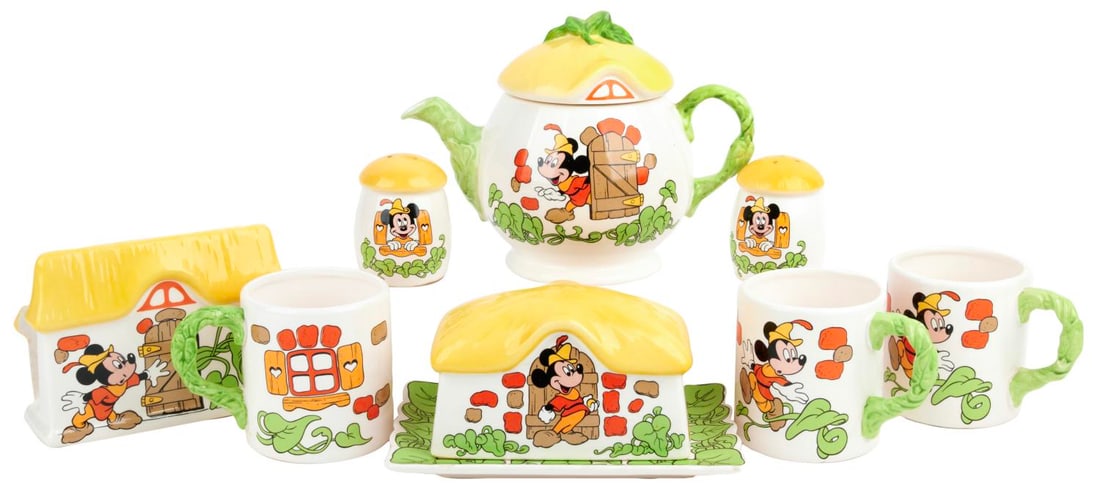 A Royal Orleans Mickey and the Beanstalk Tableware Collection.: (Royal Orleans, 1980s) A collection of Royal Orleans Mickey and the Beanstalk tableware. Included are a teapot with lid, a butter dish, salt and pepper shakers, a napkin holder, and three mugs. Measur