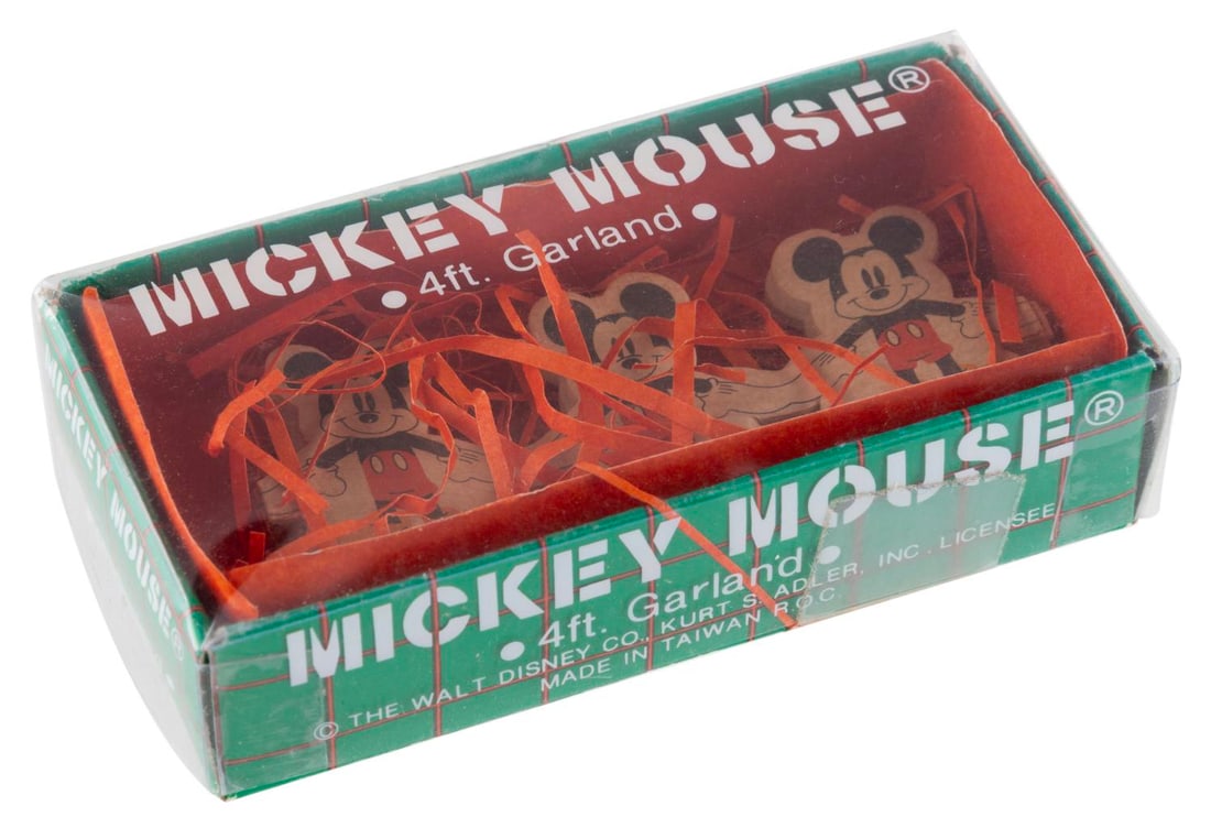 A Mickey Mouse Garland in the Original Box.: (Kurt S. Adler, Inc., 1990s) A paper garland of Mickey Mouse, produced by Kurt S. Adler, Inc. The die-cut garland is unused and comes in its original box. Measuring 4? long in its 1.75" x 3.5" and 1" 