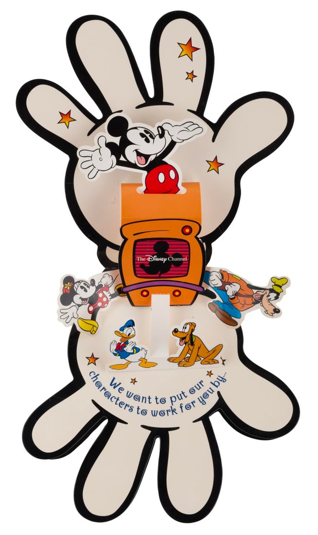 A Disney Channel Marketing Calendar Mailer.: (Disney, 1997) A Disney Channel pop-up calendar advertising the "New Disney Channel." The glove-shaped mailer opens to reveal a pop-up of Mickey and friends, with a removable fold-out calendar and