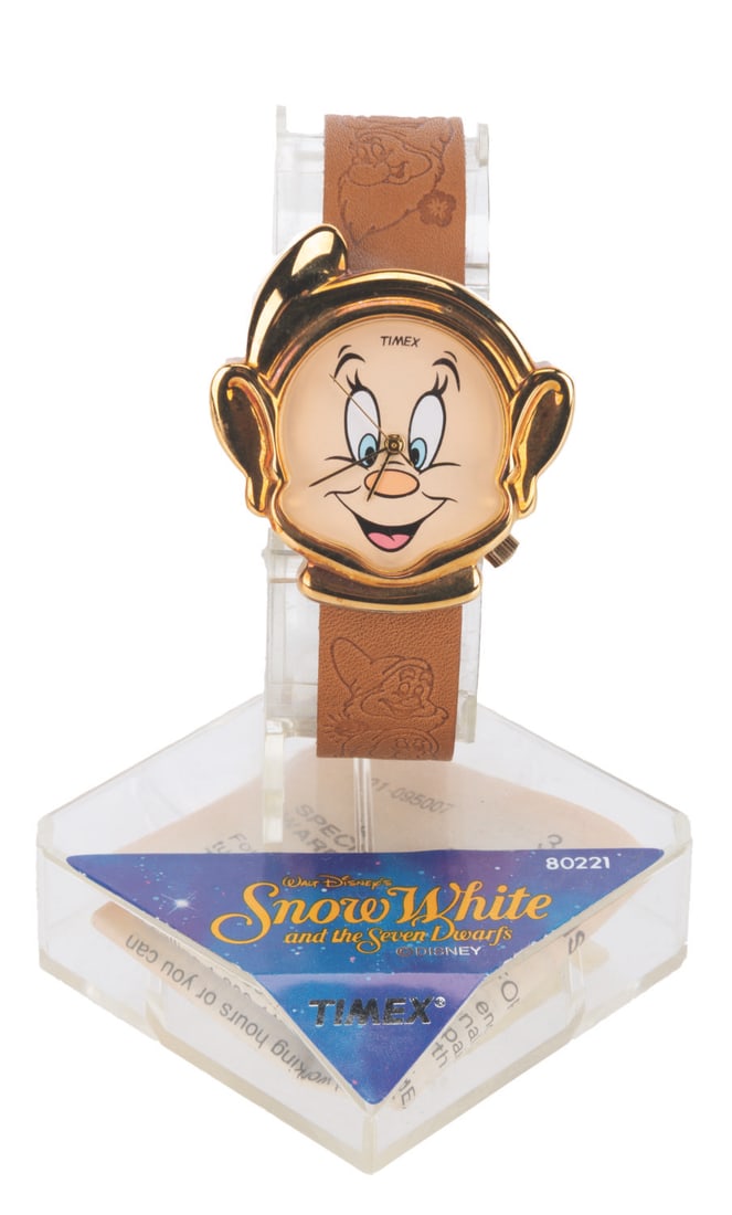 A "Snow White" Dopey Wristwatch.: (Timex, 1990s) A "Snow White" wristwatch featuring Dopey for the face and the Dwarfs embossed along the leather band. Measuring 1.5" in diameter on an 8.25" band, the watch is in fine condition,