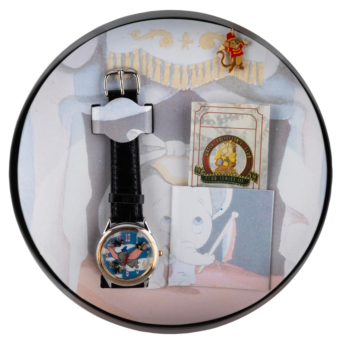 A "Dumbo" Watch Collector's Club Watch.: (Disney, 1994) A "Dumbo" watch from the Watch Collector's Club Series III. The face features Dumbo with the crows flying around as second hands. The watch comes with its original tin packaging, certif