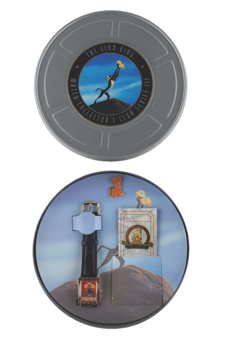 A "The Lion King" Watch and Pin Set.: (Disney Store, 1994) A "The Lion King" watch set with pin, released in a "movie reel " tin. The watch features Rafiki, and the pin is of young Simba. The set is in fine condition, with the watch