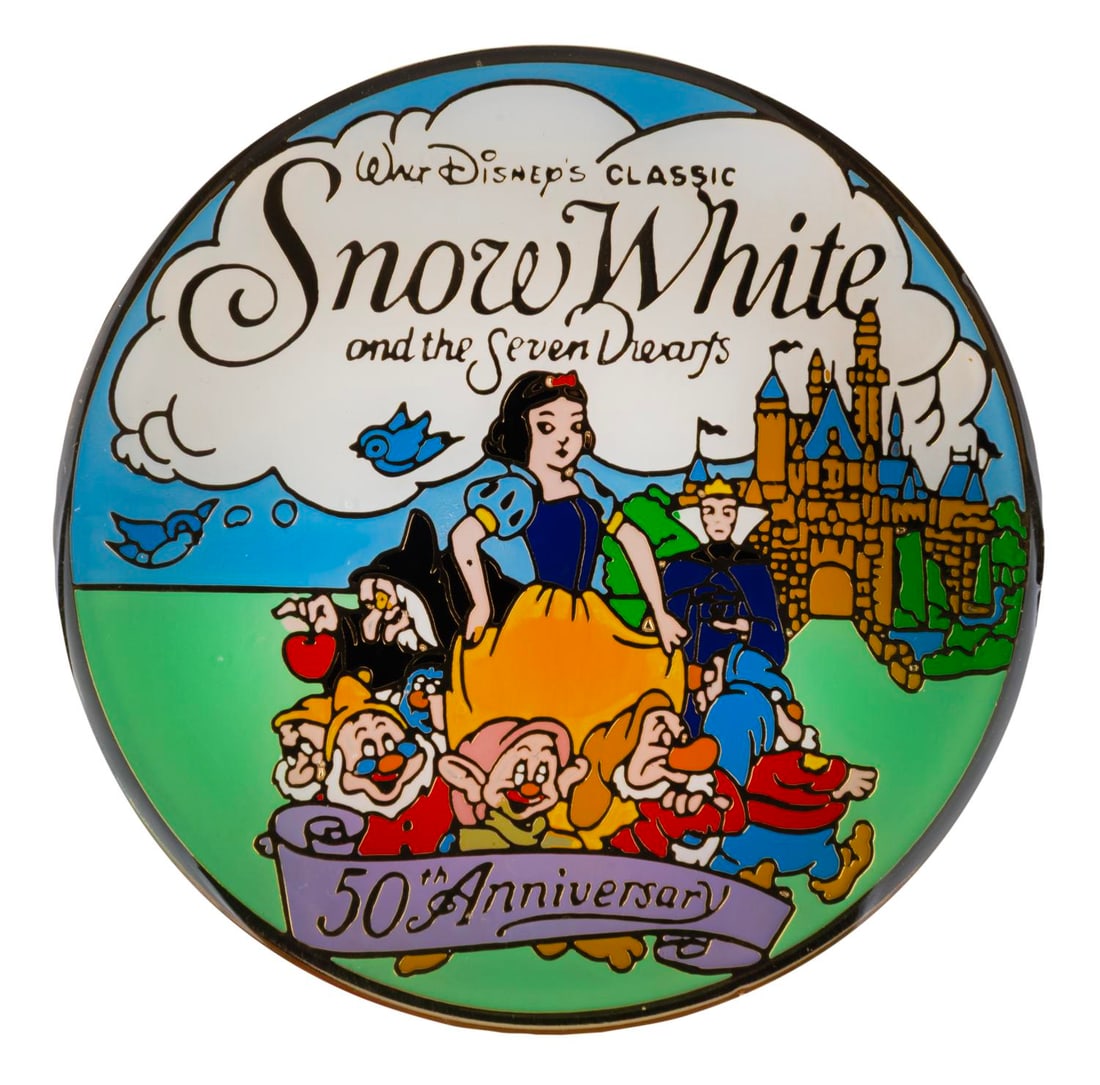 A "Snow White" 50th Anniversary Pin.: (Disney, 1987) A very large pin for the 50th anniversary of "Snow White and the Seven Dwarfs." Measuring 3" in diameter the pin is in very good condition.