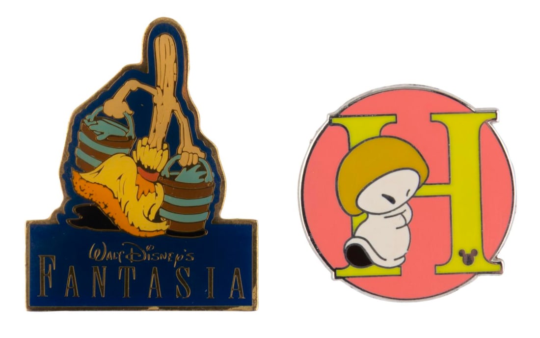 A Pair of "Fantasia" Pins.: (Disney, 1990/2009) A pair of “Fantasia” pins including a 1990 50th anniversary broom pin, and a 2009 Hop Low Hidden Mickey alphabet pin. The pins are in very good condition.