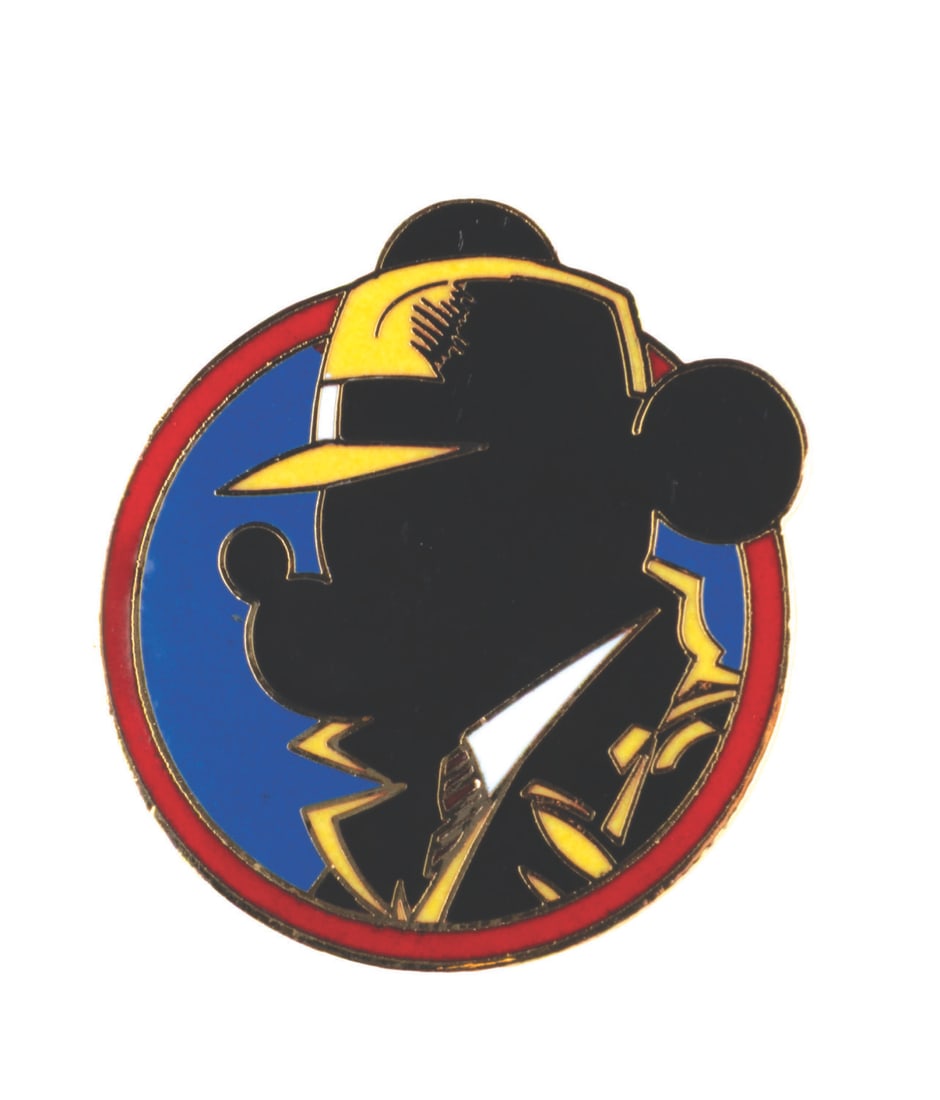 A Disneyland Cast Exclusive Mick Tracy Pin.: (Disneyland, 1990) A Disneyland Cast Exclusive pin of "Mick Tracy," parodying the popular "Dick Tracy" film logo. A Dick Tracy stage show was presented in the Park at this time. The pin is in fine con