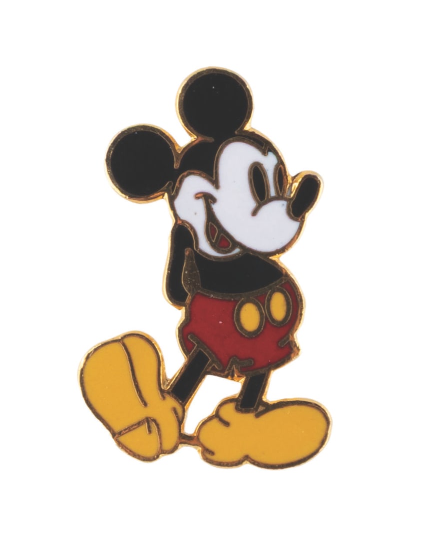 A Mickey Mouse Enamel Pin.: (Disney, 1990s) A gold colored pin of Mickey Mouse standing with his hands behind his back. Measuring 1" tall, the pin is in fine condition.