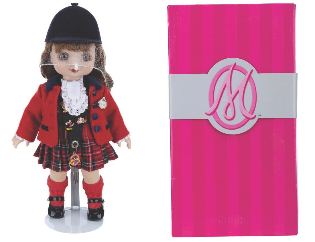 A Marie Osmond Adora Belle Disneyland Hostess Doll.: (Disneyland, 2008) A limited edition "Adora Belle" Disneyland Hostess doll by Marie Osmond. Modeled after the original Disneyland Tour Guide costumes from 1958, the doll is dressed in the familiar